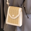 Handwoven straw crossbody bag in beige and white leather trim on dark blazer background - Off White