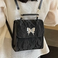 Chic black crinkled texture backpack featuring a modern silver liquid metal butterfly charm - Black