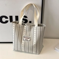 Chic vertical striped canvas tote bag in beige with sturdy woven top handles for daily use - Off White