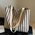 Brown and white striped corduroy tote bag with woven handles and front patch detail - Off White