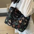 Elegant black tote bag with colorful butterfly patterns and silver chain shoulder strap - Black