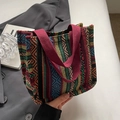 Ethnic woven tote bag with geometric patterns and deep red handles in a stylish setting - Small / Burgundy