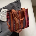 Ethnic style woven tote bag with colorful vertical stripes and durable brown handles - Small / Orange