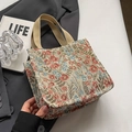 Floral jacquard small tote bag with beige woven handles in a lifestyle setting - Pink Small