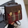 Retro plaid and brown leather backpack with golden metal buckles in a hand-held display - Large Red No Pendant