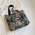 Floral jacquard tote bag with black canvas handles placed on a beige pleated dress - Large / Black