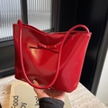 Fashionable red patent leather handbag with bow detail and glossy mirror finish - Red