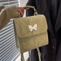 Pale green pleated backpack with metallic silver butterfly detail and top handle - Green
