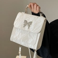 Elegant off-white pleated backpack with silver butterfly detail and top handle strap - Off White
