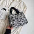 Floral canvas tote bag with black handles in a stylish lifestyle setting - Small Black