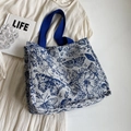 White canvas tote bag featuring blue butterfly pattern and royal blue shoulder straps - L Blue