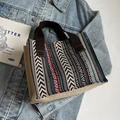 Ethnic woven tote bag with geometric patterns and brown handles on denim background - Coffee Webbing Strap Style