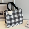 Chic black and white checkered tote bag with a white plush heart charm and woven handles - Black Large With White Heart Pendant
