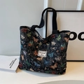 Borsa tote in tela nera con jacquard di farfalle colorate e tracolle intrecciate - Nero Grande Potenziato