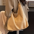 Large camel suede hobo bag shown in a lifestyle setting with a soft drape design - Khaki