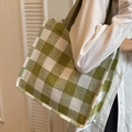 Green and white checkered canvas tote bag with wide strap on shoulder of a model - Green Large No Pendant