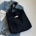 Minimalist black canvas tote bag with large capacity and designer brand label patch - Black (Heavyweight)