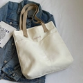 White canvas tote bag with khaki straps and front pockets, shown with blue denim jacket - White (Thickened)