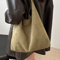 Olive green suede tote bag with large capacity for casual commuting shown on shoulder - Green