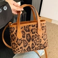 Fashionable leopard print bucket bag with brown leather handles and adjustable strap - Brown