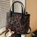Chic leopard print crossbody bucket bag with black leather trim and gold hardware - Black