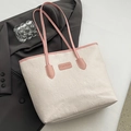 Cream tote bag with pink handles featuring embossed cartoon patterns and fashion label - Pink & White With Charm