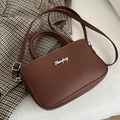 Dark brown rectangular crossbody bag with silver lettering and thin adjustable strap - Brown