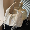 White corduroy drawstring shoulder bag with textured finish and branded patch - White