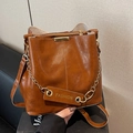 Deep brown bucket bag with gold chain hardware and fashion tag in faux leather - Brown