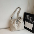 Minimalist beige drawstring bucket bag in lightweight nylon fabric with adjustable strap - Beige Grey