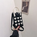 Black knitted crossbody mini bag with white 3D heart patterns and round handles - Black
