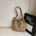 Minimalist khaki drawstring bucket bag with large side pockets and wide adjustable strap - Khaki