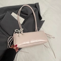 Pink underarm pillow bag with pearl bow and drawstring details on a grey blazer - Pink + Pearl Bow Charm