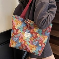 Grande borsa tote in jacquard floreale rosso vintage mostrata su una modella - Grande / Borgogna