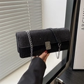 Sparkly black evening clutch bag with silver chain strap and rectangular metal clasp - Black