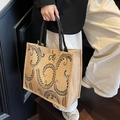 Detail of linen tote bag featuring black vintage floral patterns and woven handles - Leaf Print