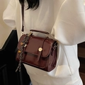 Vintage wine red glossy leather crossbody bag with gold buckle and woven pendant detail - With Bell Pendant / Burgundy