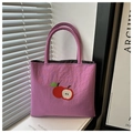 Close-up of purple nylon tote bag featuring red apple embroidery and cylindrical handles - Rose Pink