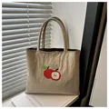 Detailed embroidery of red apples on a light khaki nylon tote bag for women - Khaki