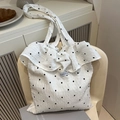 White seersucker tote bag with black floral pattern and large ruffled edge details - White
