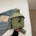 Minimalist grass green nylon crossbody bag with drawstring pocket on white bedding - Green
