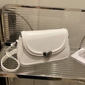 Chic white saddle bag featuring a unique silver heart buckle and adjustable shoulder strap - White