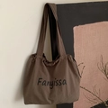 Dark brown canvas tote bag with drawstring closure and black Fanyissa script text - Brown