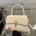 Beige woven leather crossbody bag with golden horseshoe lock and top handle - White