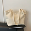 Minimalist beige tote bag in faux leather texture with adjustable shoulder straps - Off White