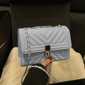 Light blue quilted leather crossbody bag with silver hardware and chain strap - Blue