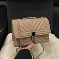 Elegant beige quilted crossbody bag with V-shaped stitching and silver metal lock closure - Khaki