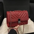 Deep red chevron quilted leather crossbody bag with silver chain strap and push-lock - Red