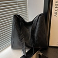 Large black woven leather tote bag with wide shoulder strap in a minimalist style - Black