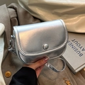 Chic silver metallic saddle bag with round buckle closure and textured faux leather finish - Silver